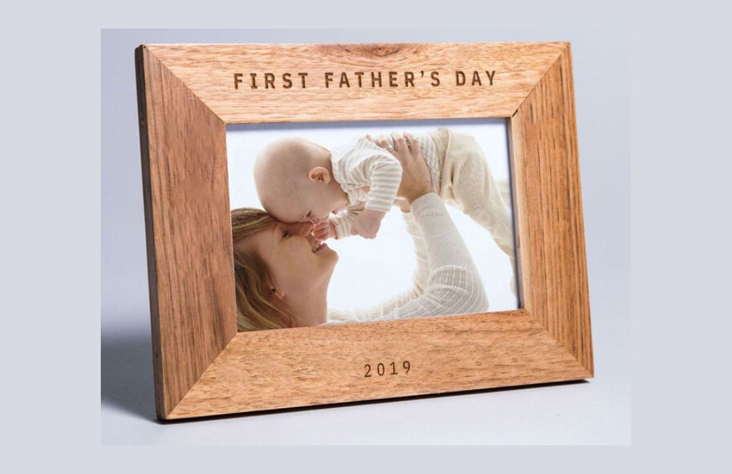 one of the best first fathers day gifts is an engraved photo frame